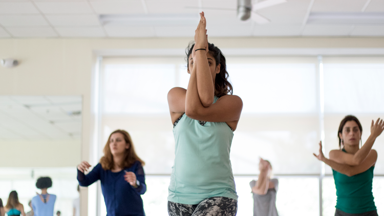 Student practicing yoga at Carmichael Complex