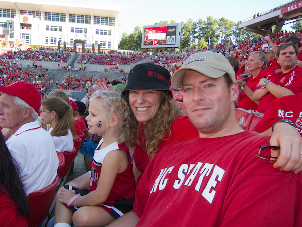 Michelle Wobker with daughter and husband at NC State football game.