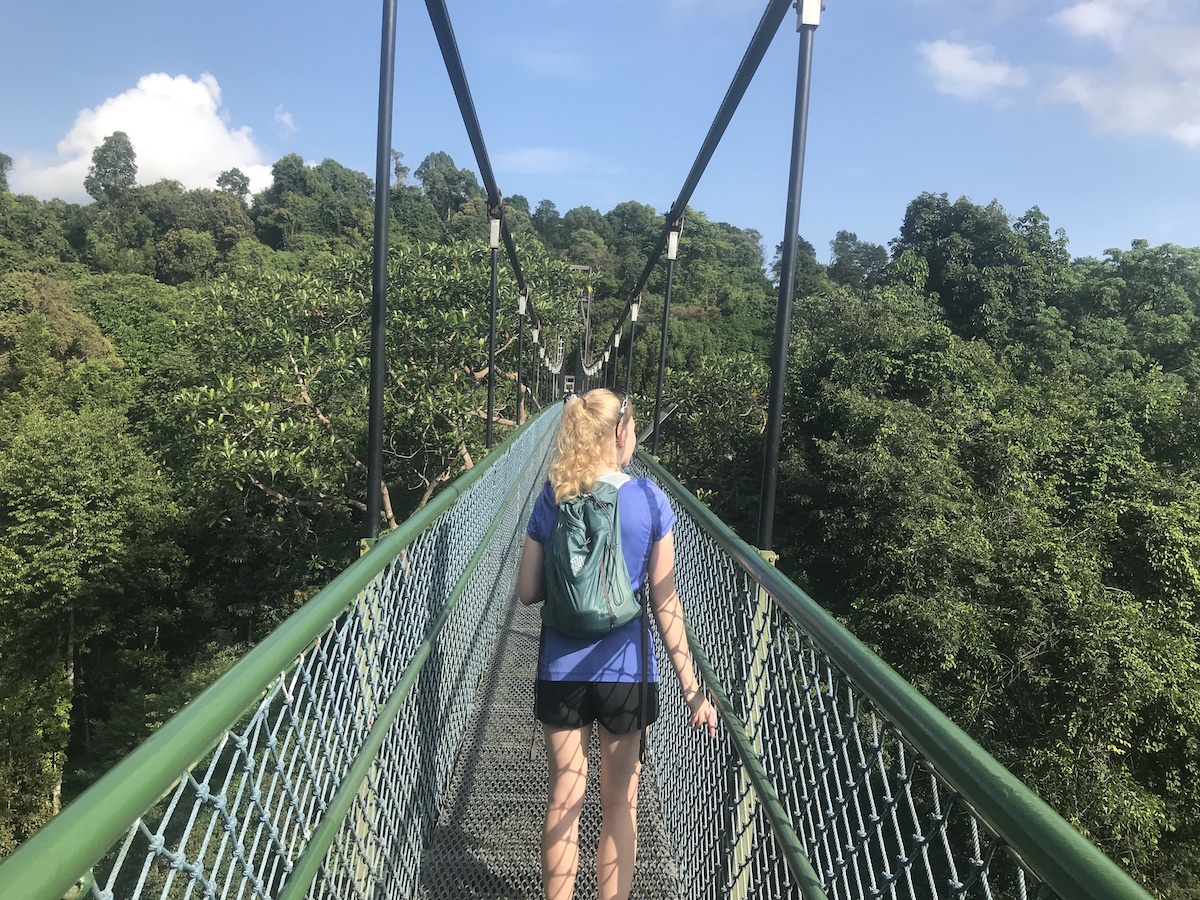 Katie Ryan walks across a suspension bridge in Singapore