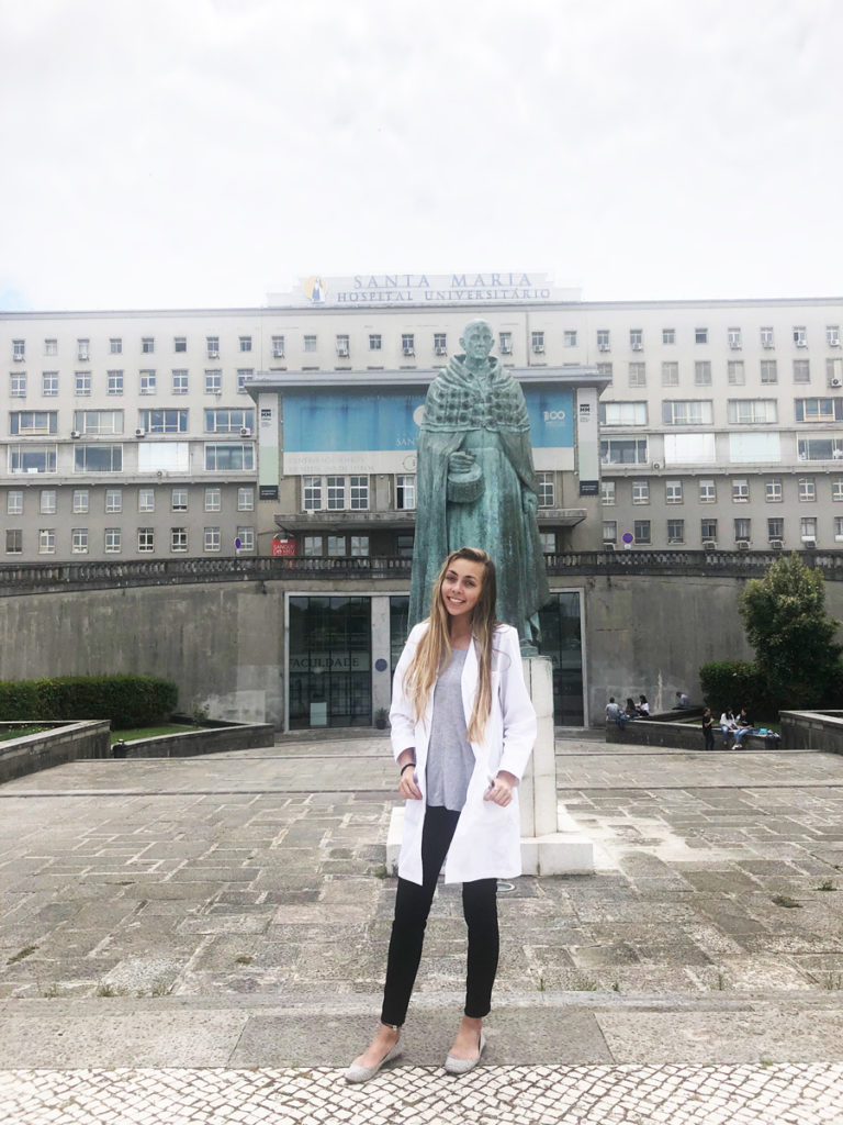 Tori stands outside, in front of the Portugal hospital where she shadowed.