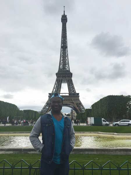Tirezz Hudson stands near the Eiffel Tower