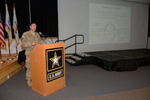 Major Blake Schwartz giving presentation at symposium