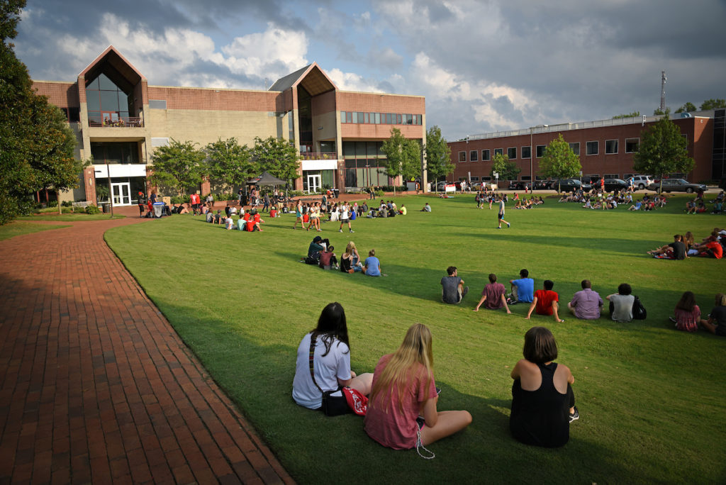 Students sit on the lawn outside Witherspoon