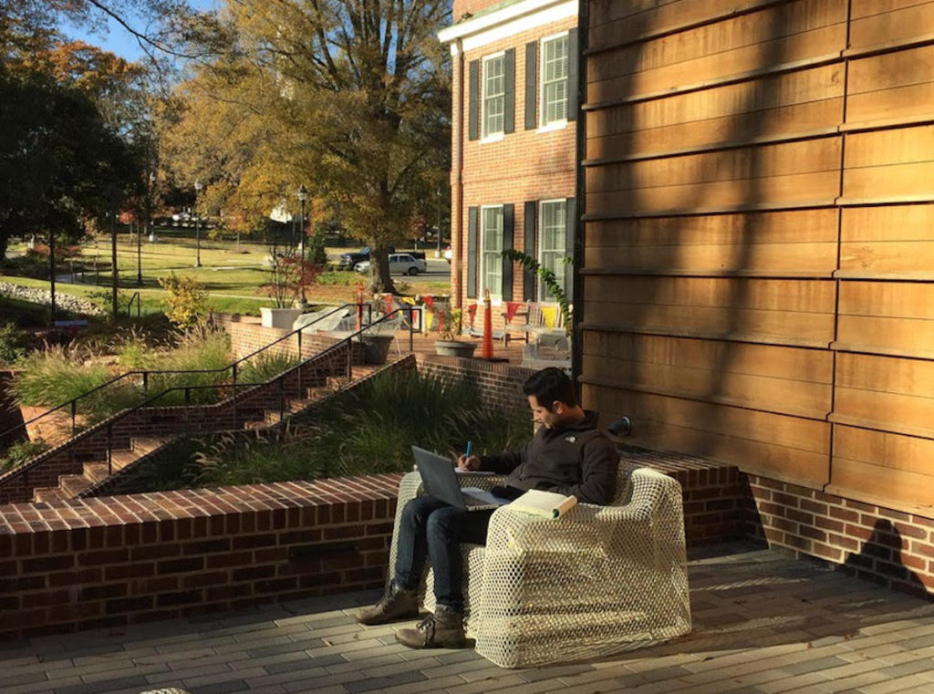 A student studies in a chair outside The Gregg museum.