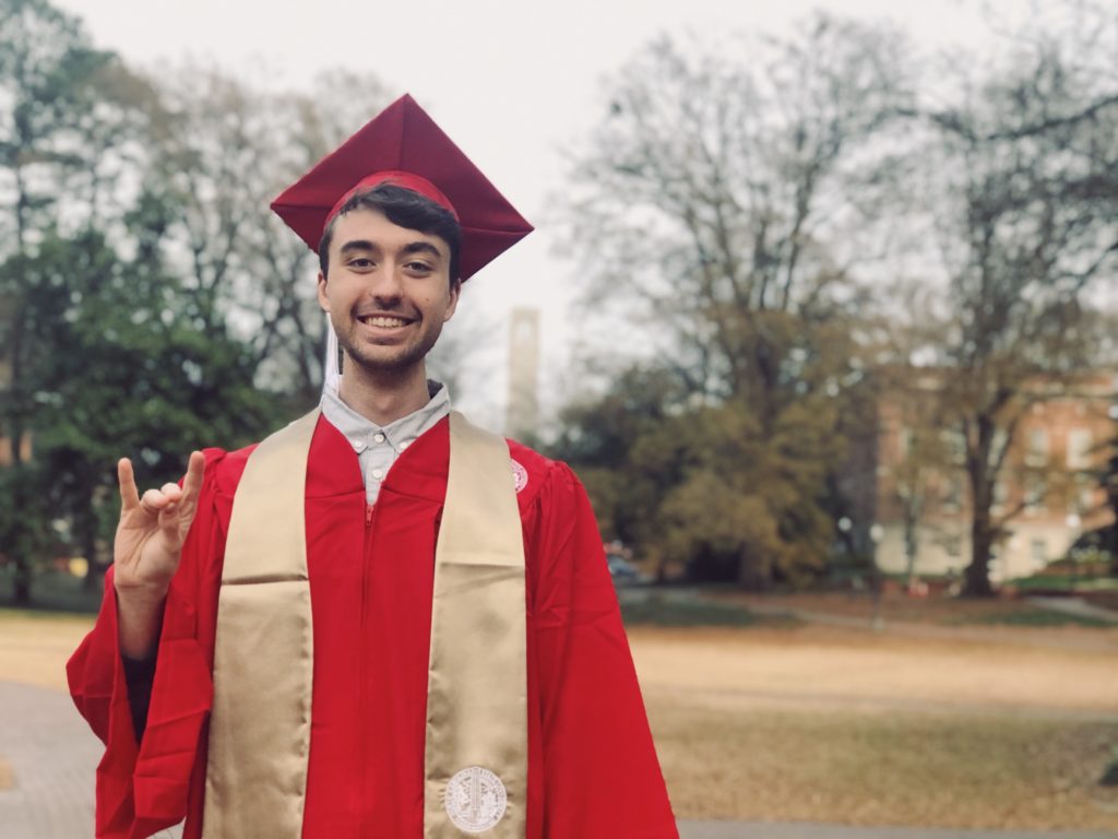 Colton Botta in his NC State University graduation robes 