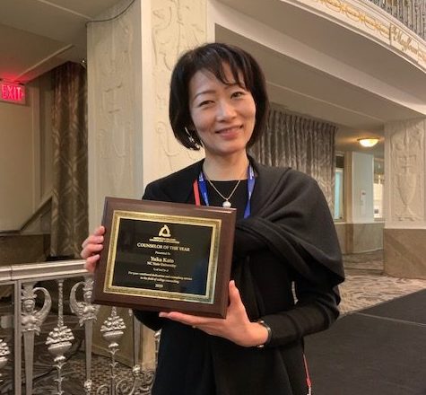 Yuka Kato holds her Counselor of the Year award from the American College Counseling Association