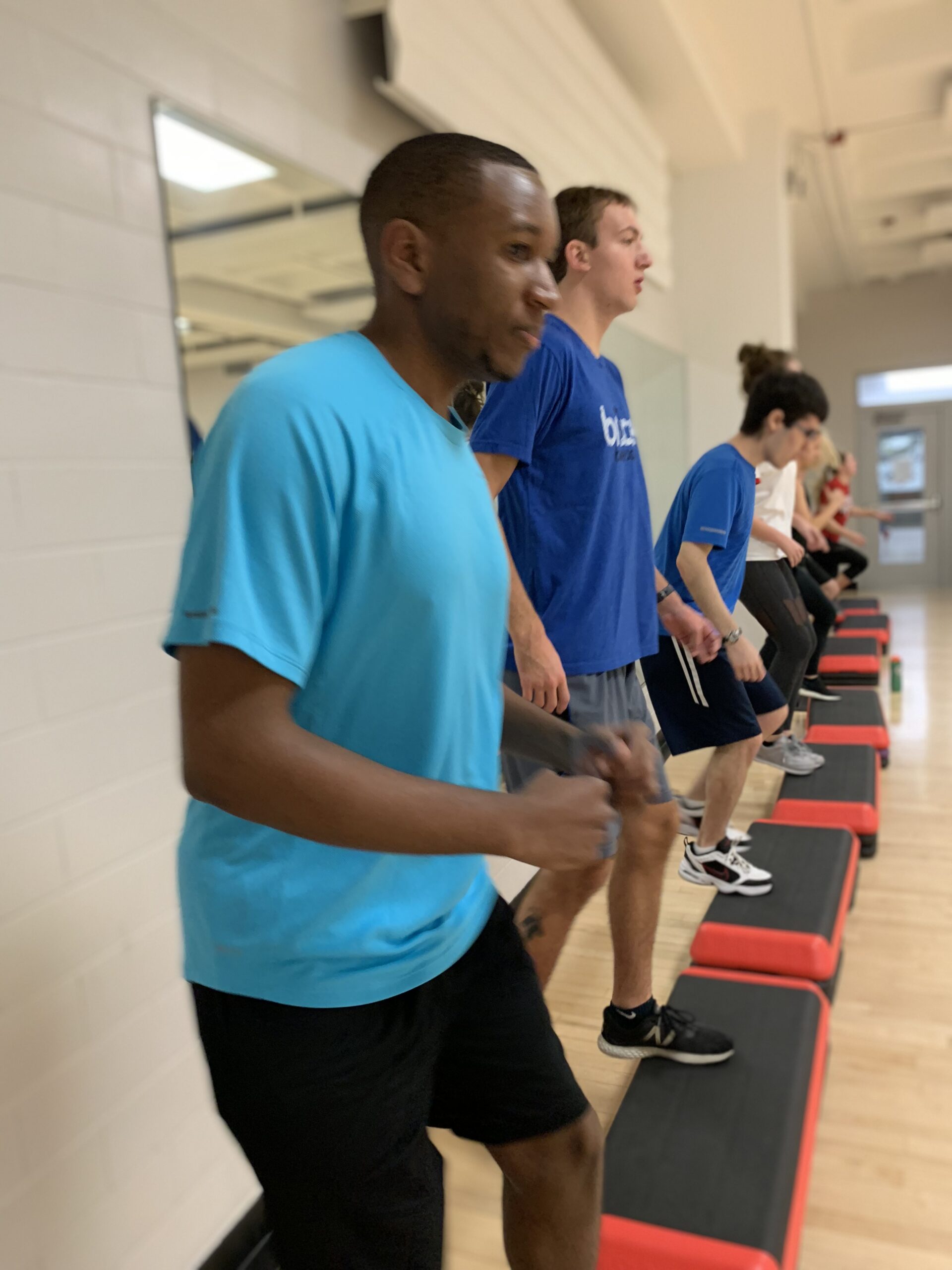 Students participate in a high-stepping workout during a Health and Exercise Studies course