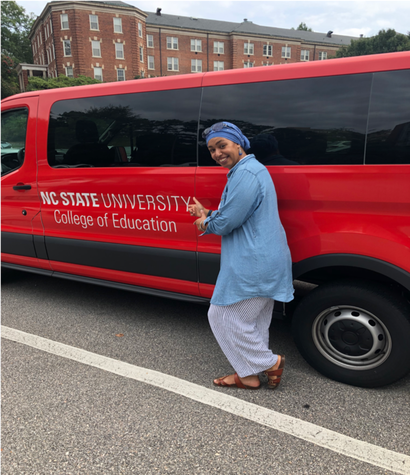 Hakima Harris poses next to a van for the College of Education