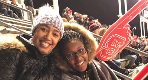 Hakima Harris (left) and her daughter at an NC State football game a month before her cancer surgery