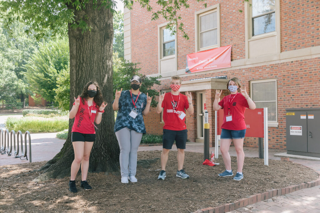 Kailee Grable (right) and fellow resident mentors pose for a photo during new student move-in
