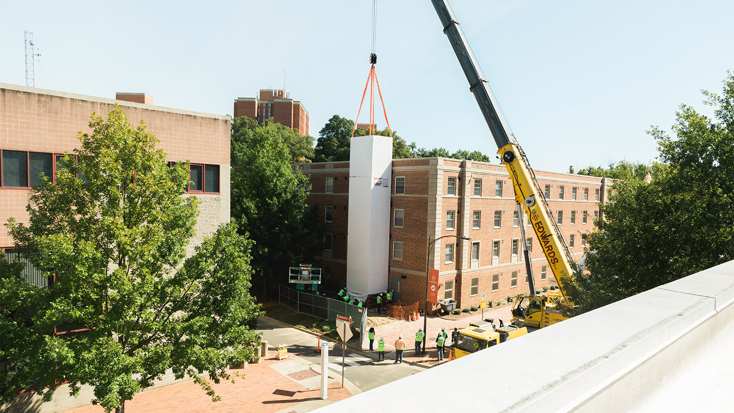 A construction crane places the elevator shaft on the side of Tucker Hall