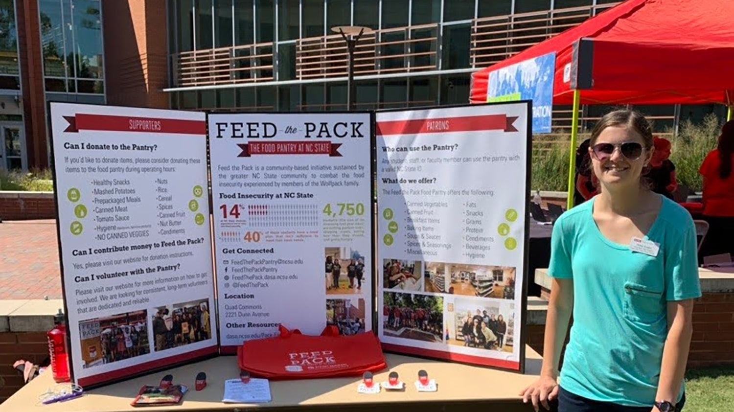 Rose Krebs standing next to a display about Feed the Pack on the Brickyard