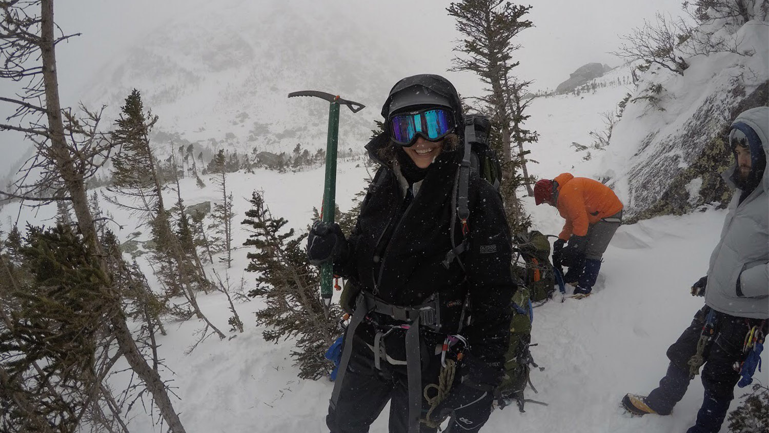 Alyssa Stroker holds a pick axe during a mountain climb in the snow