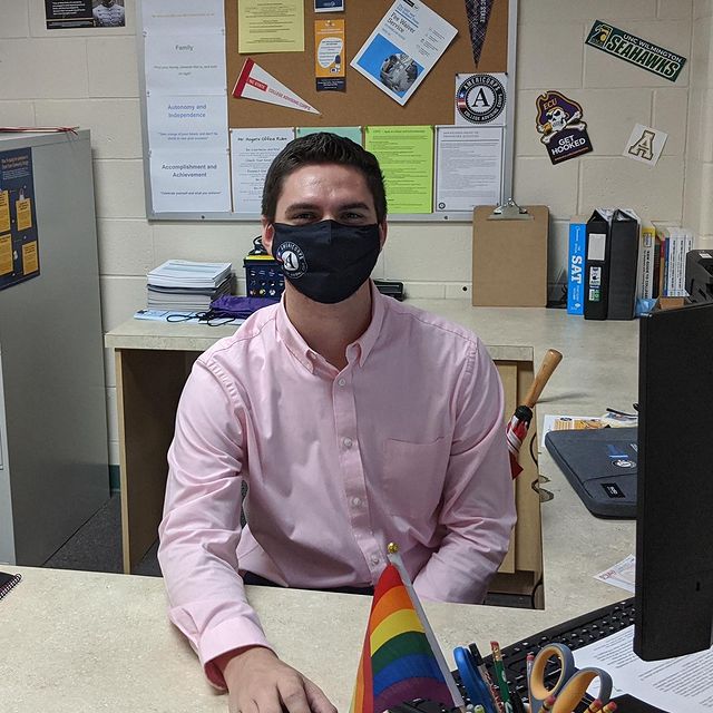 Kevin Hogan sitting at a desk, wearing a mask
