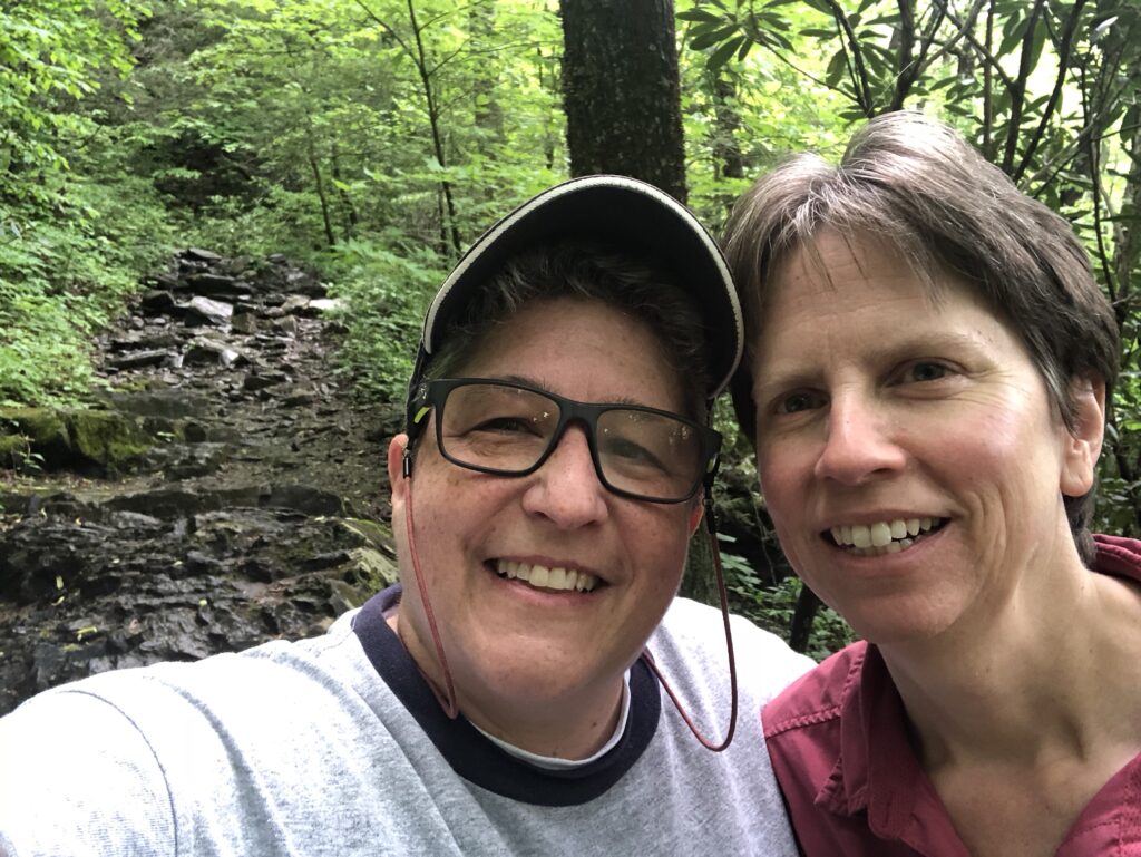 Justine Hollingshead and her wife, Debbie Dean on a hike in nature