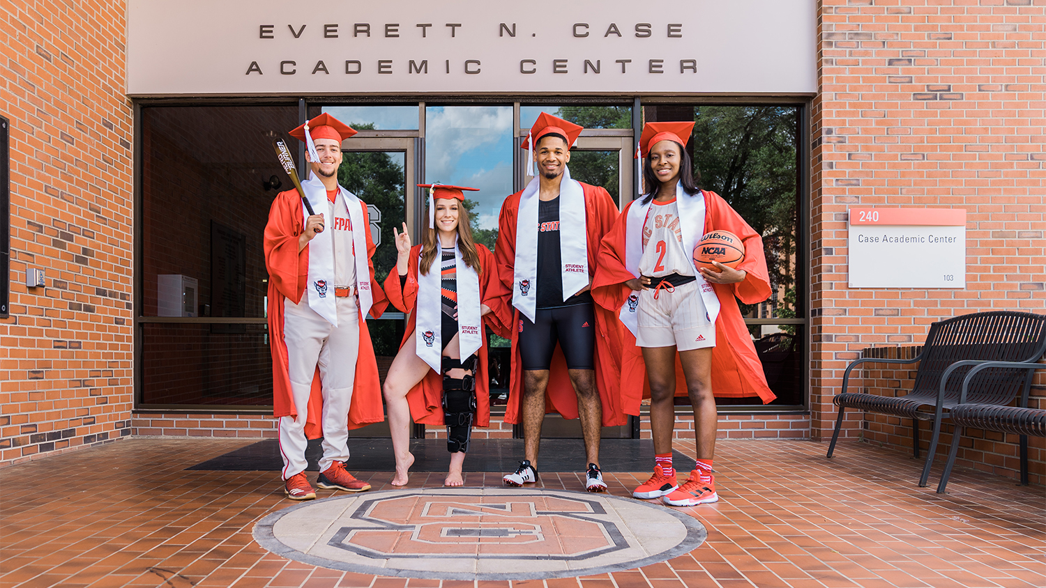 A group of four student-athletes outside the Everett N. Case Academic Center