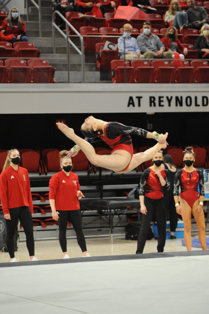 Chloe Negrete completes a jump during a gymnastics competition in Reynolds Coliseum
