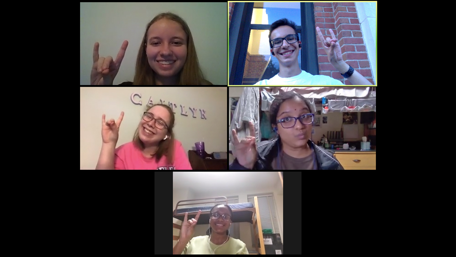 A screenshot of a Zoom video call, with five students make a wolfie sign through their windows