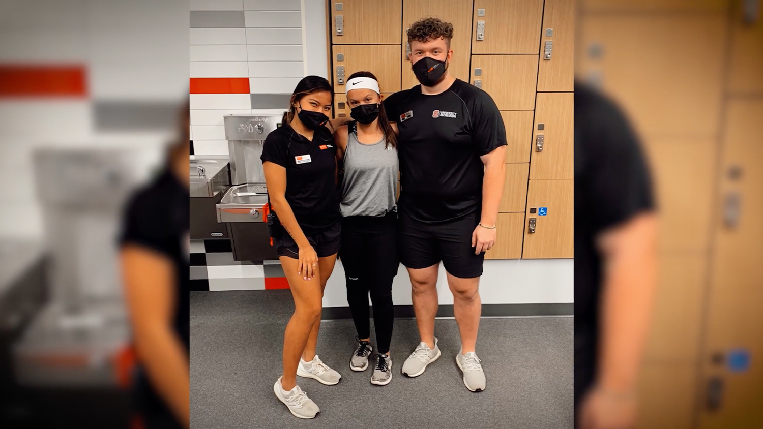 Three students wearing masks and gym clothing