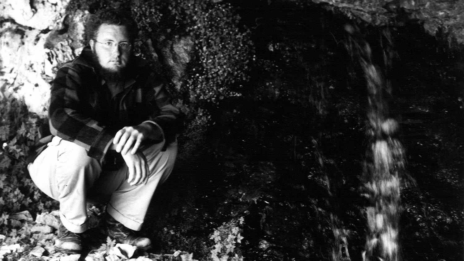 A black and white photo of Roger Manley in Mavroneri, the Cave of the Styx