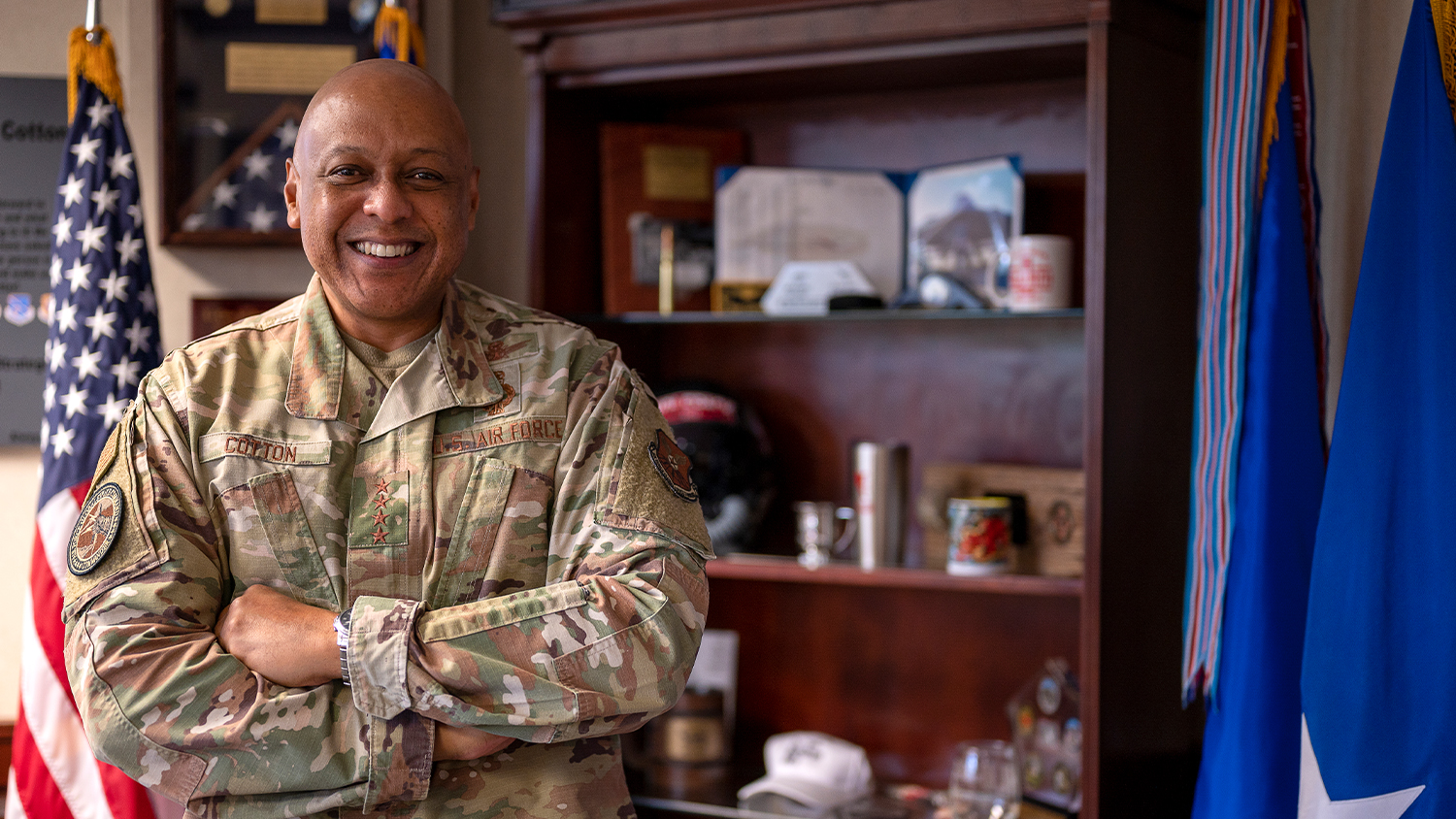 Gen Anthony Cotton in his military uniform and standing with his arms crossed in his office