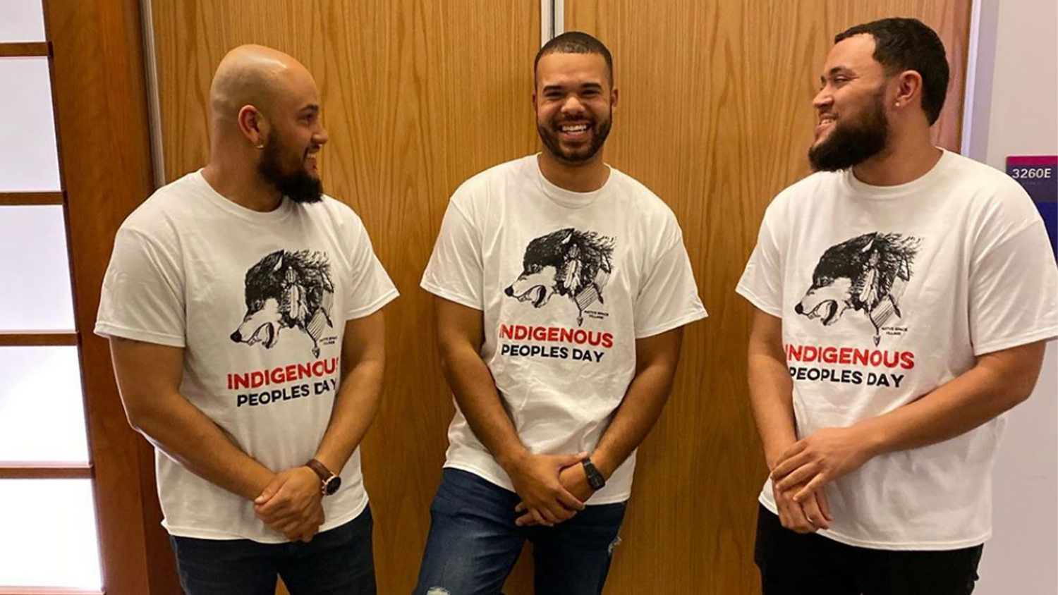 Three members of Native Space wearing Indigenous People's Day T-shirts