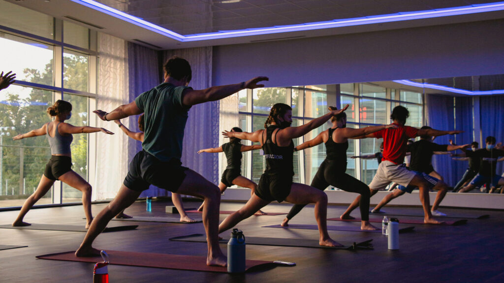 Students in a yoga class strike poses