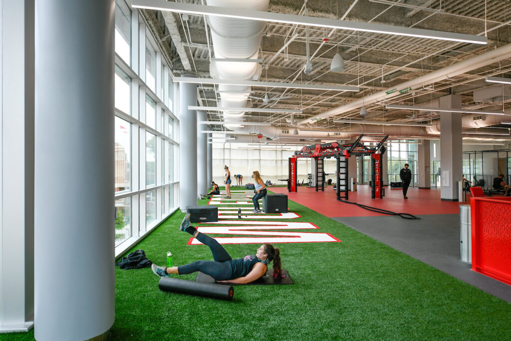 Gym members exercise on the turf on the top floor of the Wellness and Recreation Center