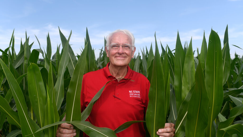 Bob Patterson emerges from a field of plants