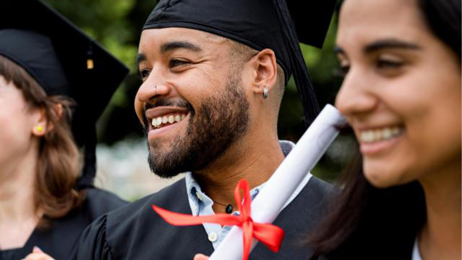 A Smiling graduate holding a diploma