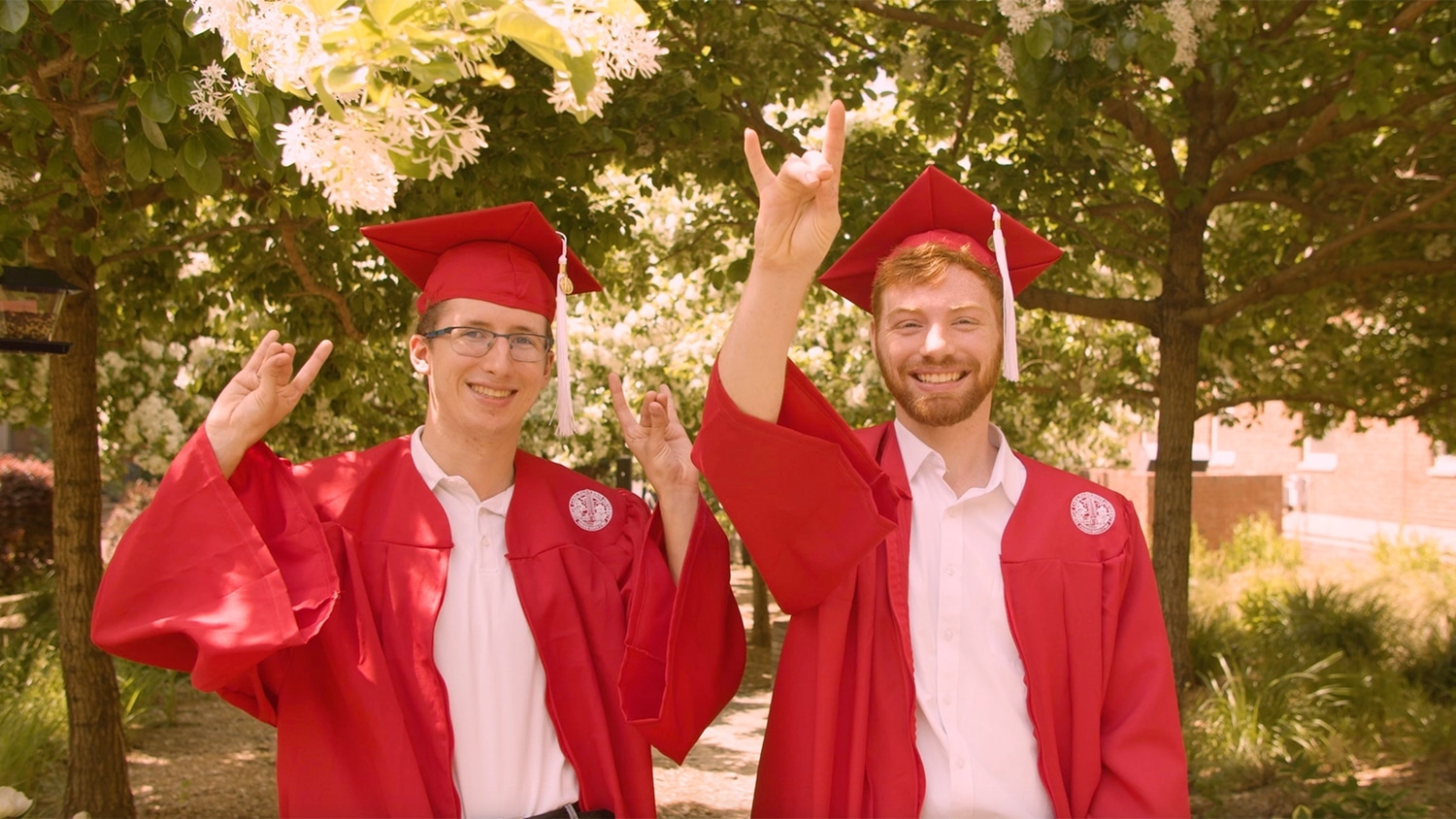 Parker Mitchell and Noah Weaver pose in their grad caps and gowns