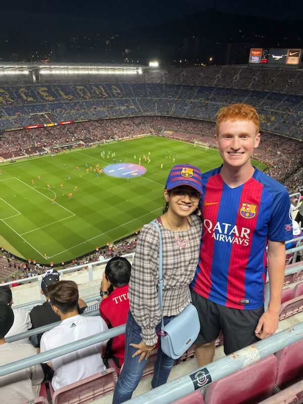 Kobrin and Manasi Krishnakumar in the stands of a large soccer stadium.