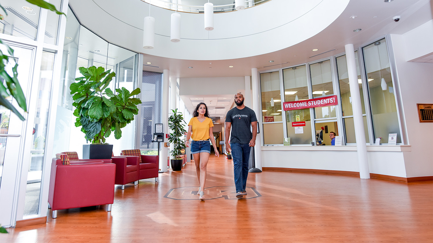 Two students walk through the main lobby of the student health center
