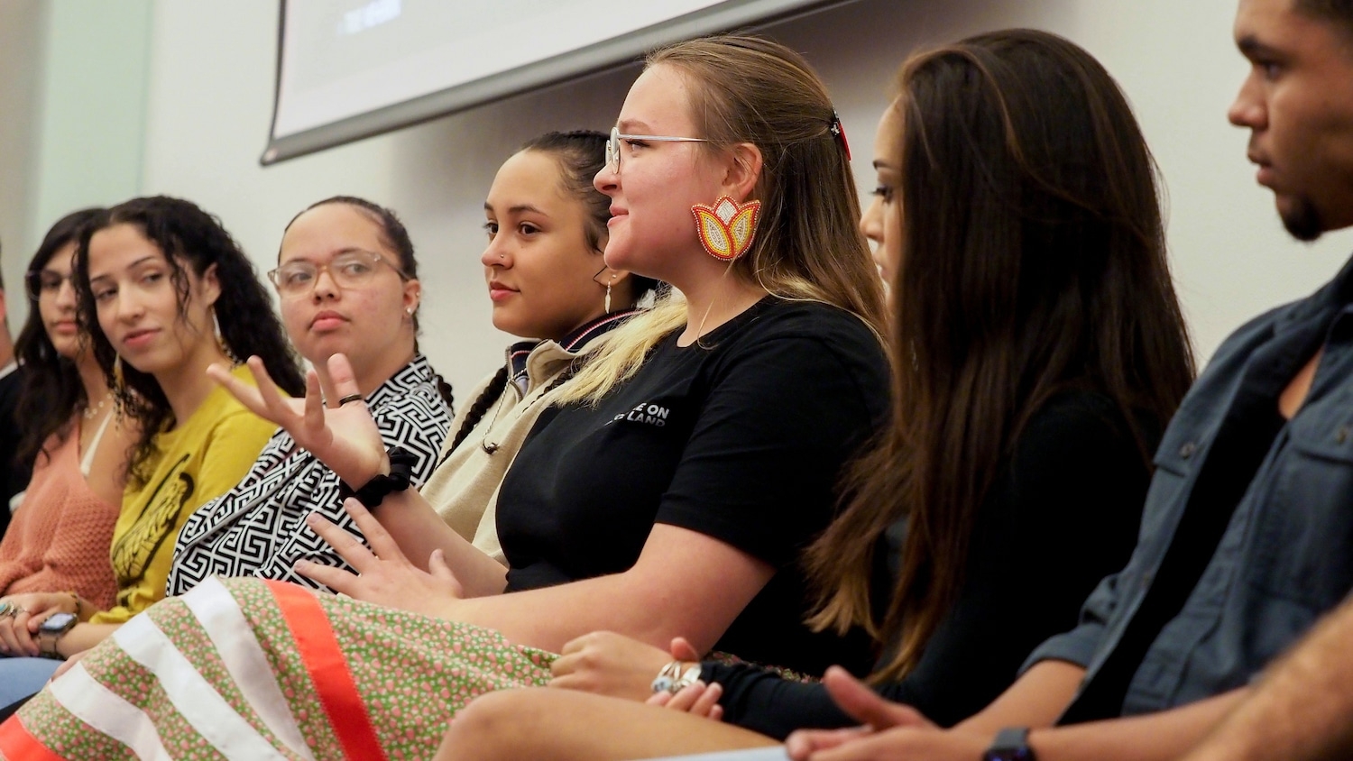 Native students sit side by side on a panel.
