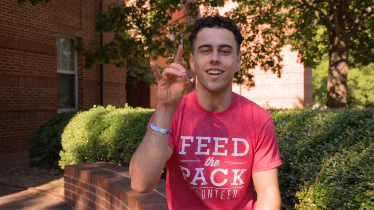 Cameron Morris does the wolfie in his Feed the Pack shirt