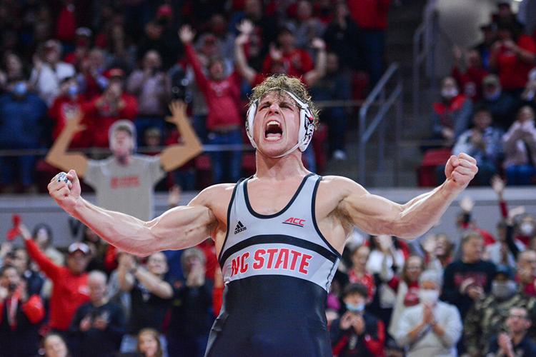 Redshirt sophomore Trent Hidlay celebrates his 2-1 decision victory over Virginia Tech\'s Hunter Bolden in the 184 pound match at Reynolds Coliseum on Feb. 20, 2022. This photo by Technician’s Griffin Bryant won best sports feature photo in the CMA Pinnacle Awards.