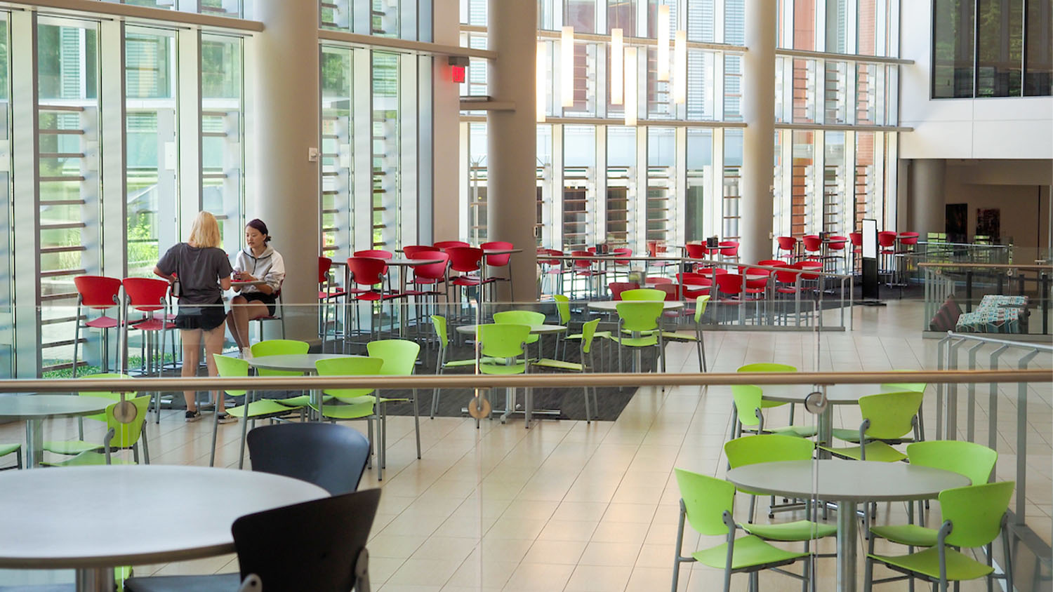 Two people sit at a table in the food court in Talley Student Union