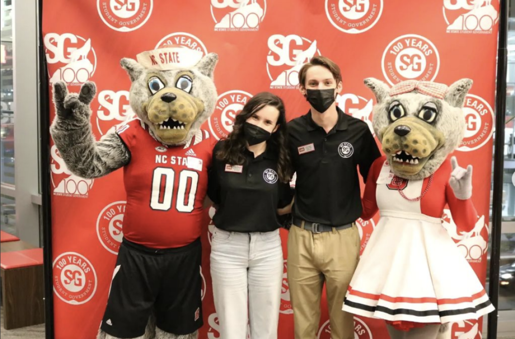 Mr. and Mrs. Wuf pose with current students and alumni from Student Government at a celebration early in 2022.