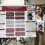 Caroline Grant with their poster and holding a book