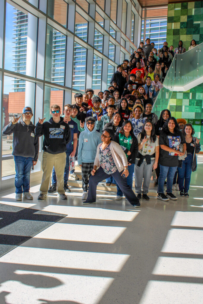 Terri Long poses in front of a large group of students in the Plant Sciences Building