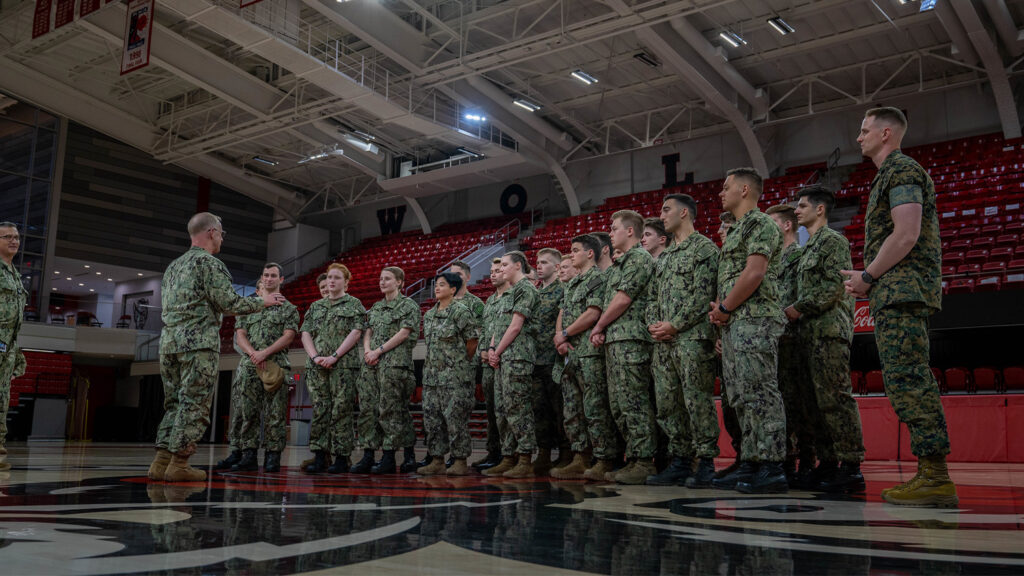 Caudle speaks to the entire group of cadets in the center of the gym in Reynolds Coliseum