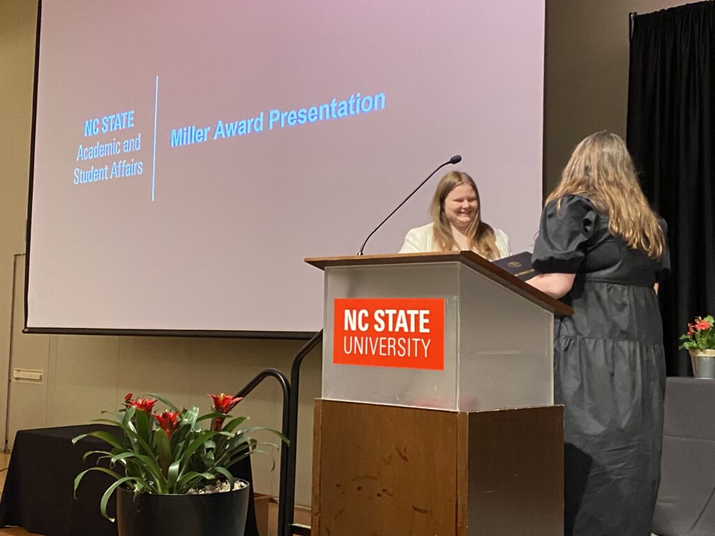 Emma Johnson receives the Alex Miller Award for Outstanding Student after delivering the Scholars Program Graduation Recognition Ceremony student address
