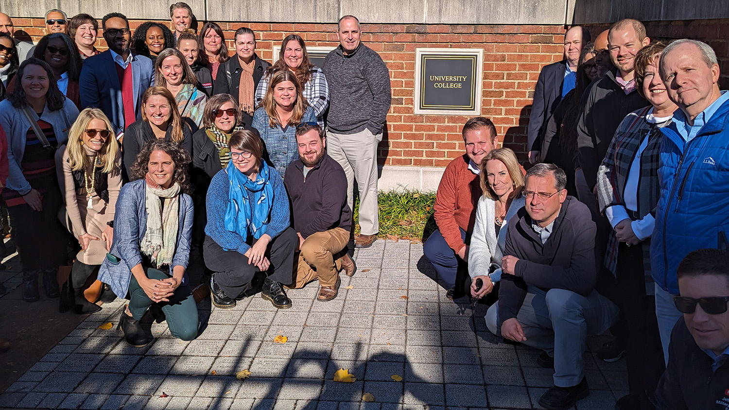 Faculty and staff from the Division of Academic and Student Affairs gather around the new University College Plaque at the Dorothy and Roy Park Alumni Center on Centennial Campus.