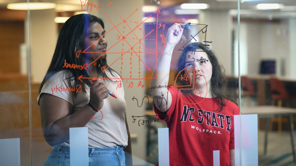 NC State students draw on a white board in D.H. Hill Library.