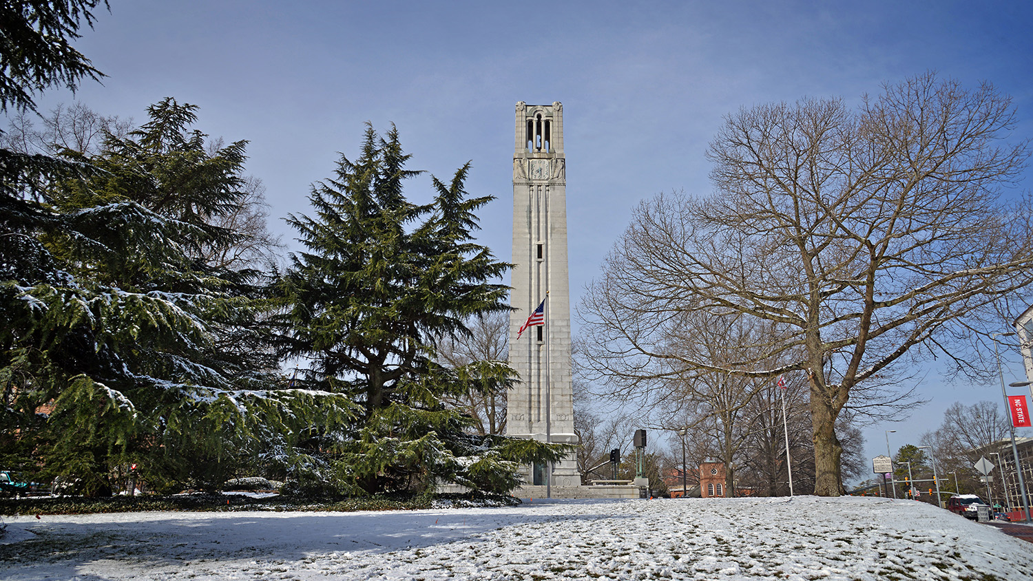 NC State's Memorial Bell Tower on a snowy horizon.