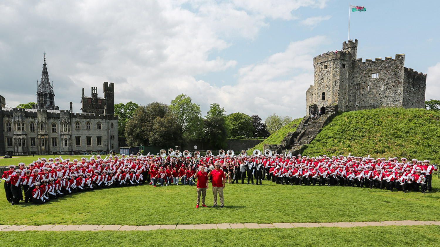 The NC State Marching Band gathers in front of a castle in Wales.