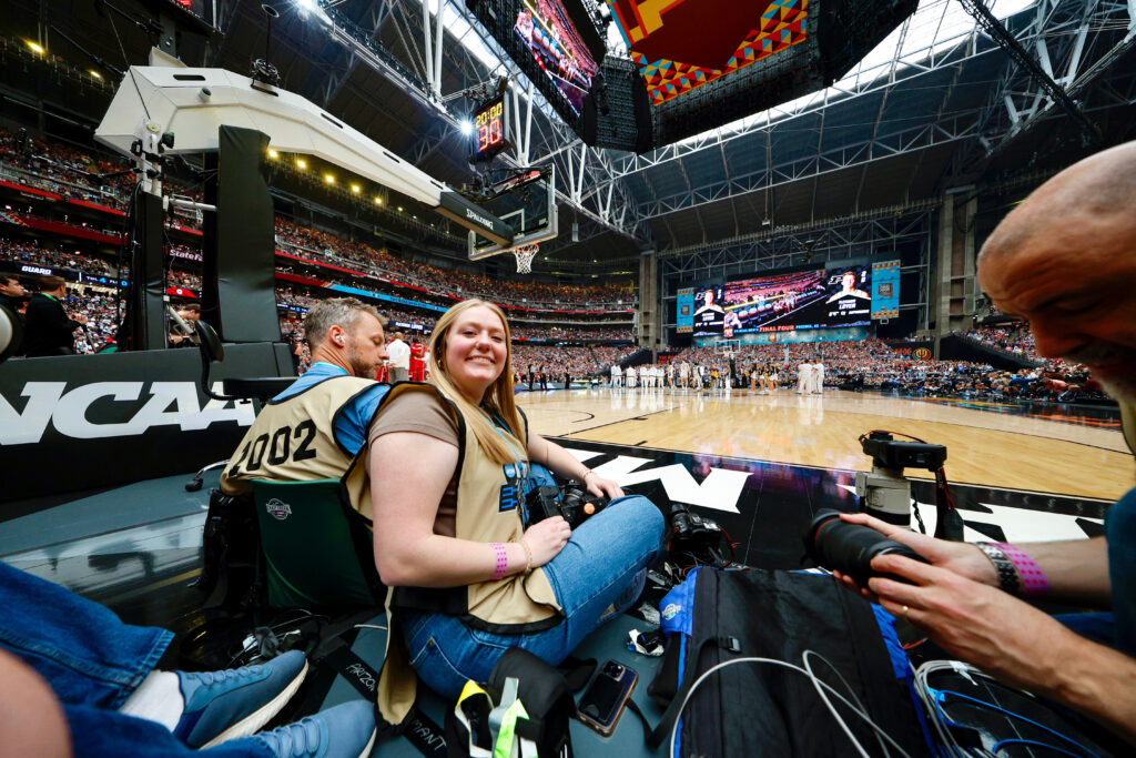Technician Senior Staff Photographer Hallie Walker sets up on photo row at the NCAA Men's Final Four. 