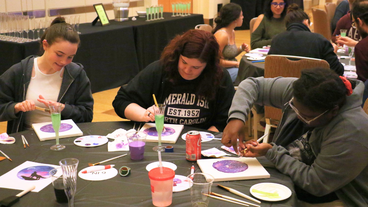 Students painting at a Whine and Design event