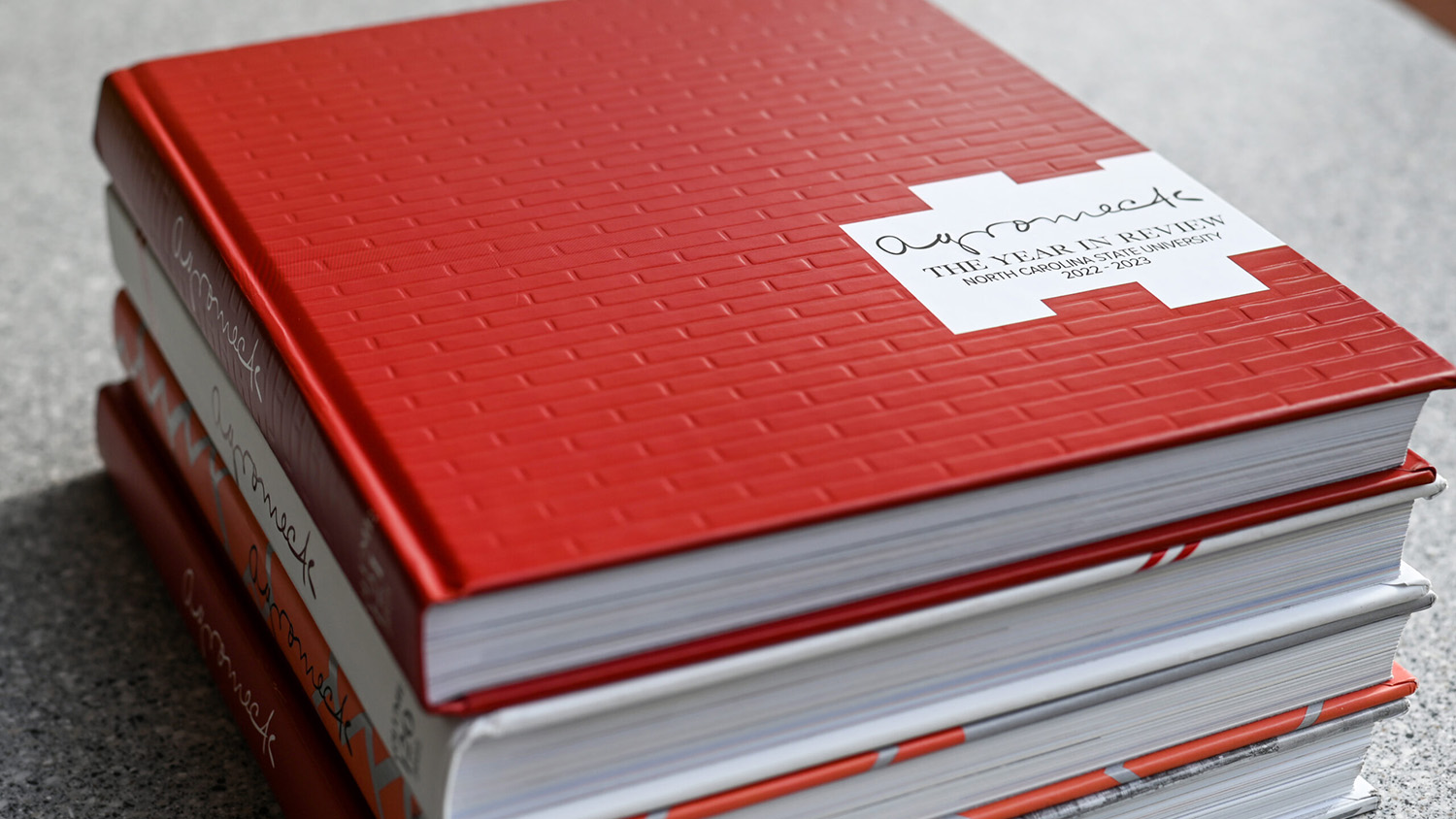 A stack of the four most-recent editions of Agromeck, NC State's yearbook and its oldest publication.