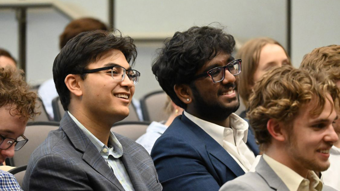 Anil Gordon, left, takes in a summer lecture at George Mason University.